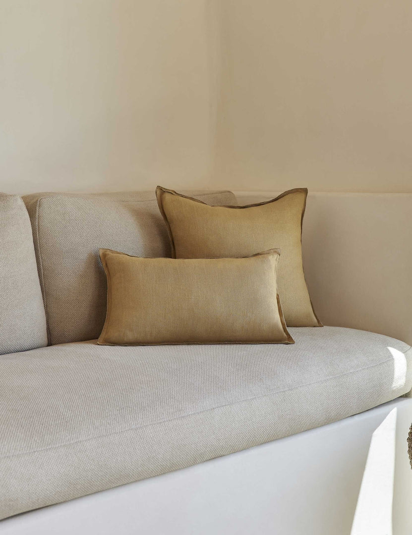 #color::marigold #style::square #fill type::with-feather-down-insert #fill type::pillow-cover-only | The arlo Marigold flax linen pillow in its lumber and square sizes sit together on a natural linen sofa