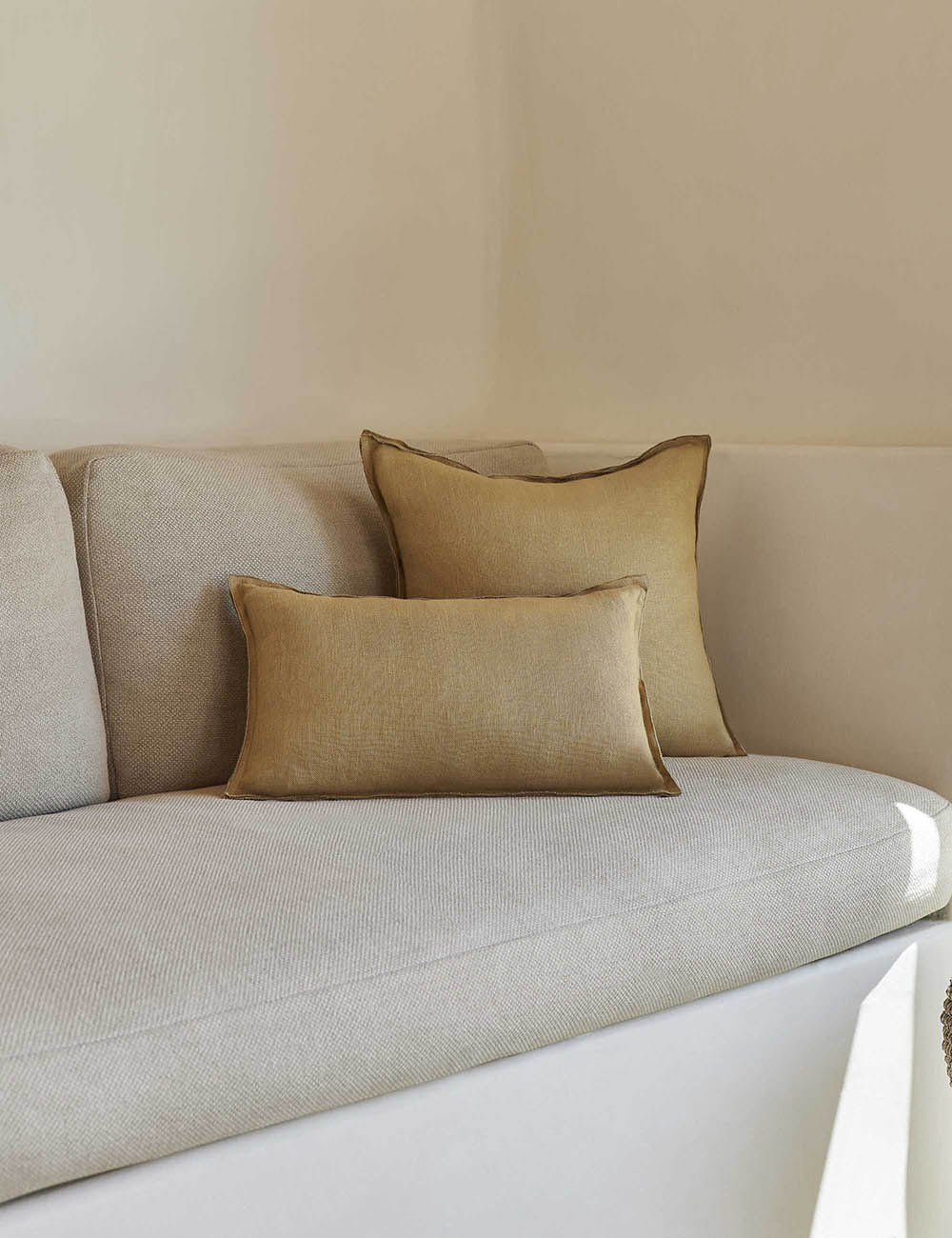 #color::marigold #style::lumbar #fill type::with-feather-down-insert #fill type::pillow-cover-only | The arlo Marigold flax linen pillow in its lumber and square sizes sit together on a natural linen sofa