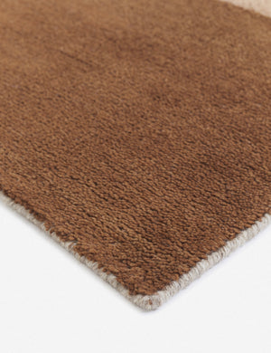 Close-up of the corner of the Benita natural toned hand-knotted floor rug by Nina Freudenberger