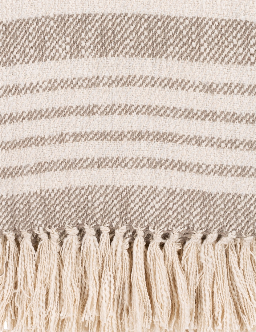 #color::taupe | Close-up of the edge of the Elulia woven two-tone taupe throw with fringed ends