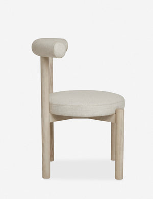 Side view of the Dame minimalist rounded open-back dining chair with ivory upholstered seat and ash wood frame
