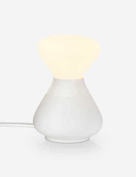 | The Reflection Noma white table lamp by Tala with its light on