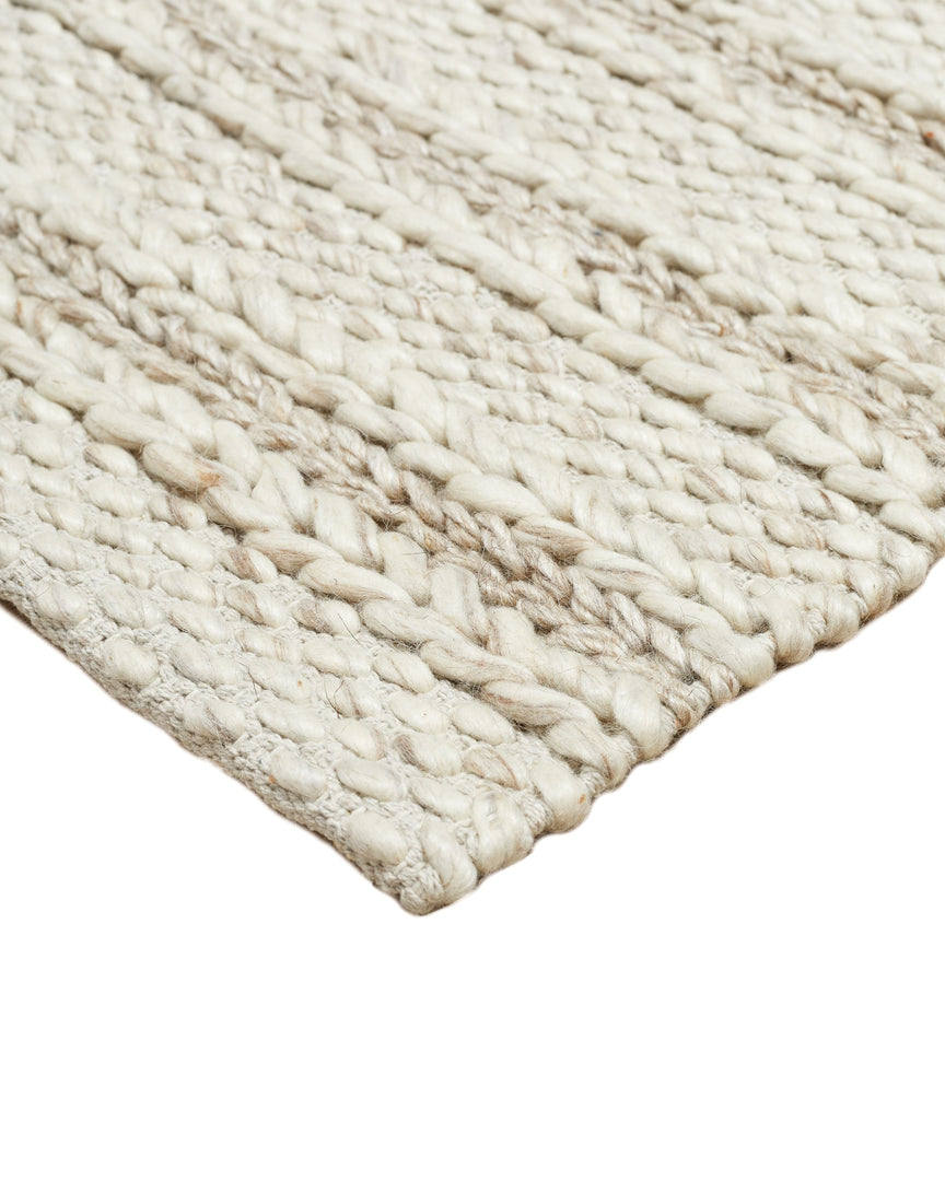 #size::3--x-5- #size::5--x-8- #size::8--x-10- #size::9--x-12- #color::soft-sand #size::10--x-14- | Detailed view of the corner and the braided texture of the of the Estie white rug | Corner of the Estie rug