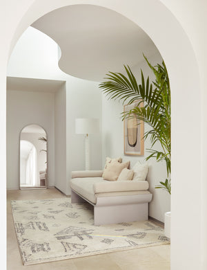 The Giles Moroccan Shag Rug lays in a hallway under a wide ivory linen bench and a white textural floor lamp with a ribbed base