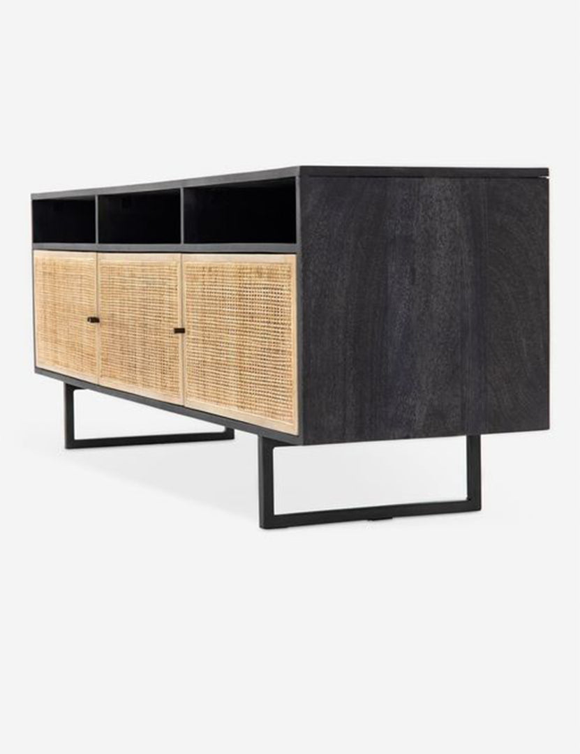 #color::black-and-natural | Angled view of the Hannah black mango wood media console with cane doors.