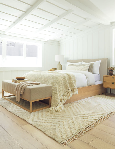 #color::white #size::euro-sham | The Set of two european flax linen white pillowcases by cultiver sit on a natural and wooden framed bed in a bedroom with white paneled walls and a cream chevron patterned rug