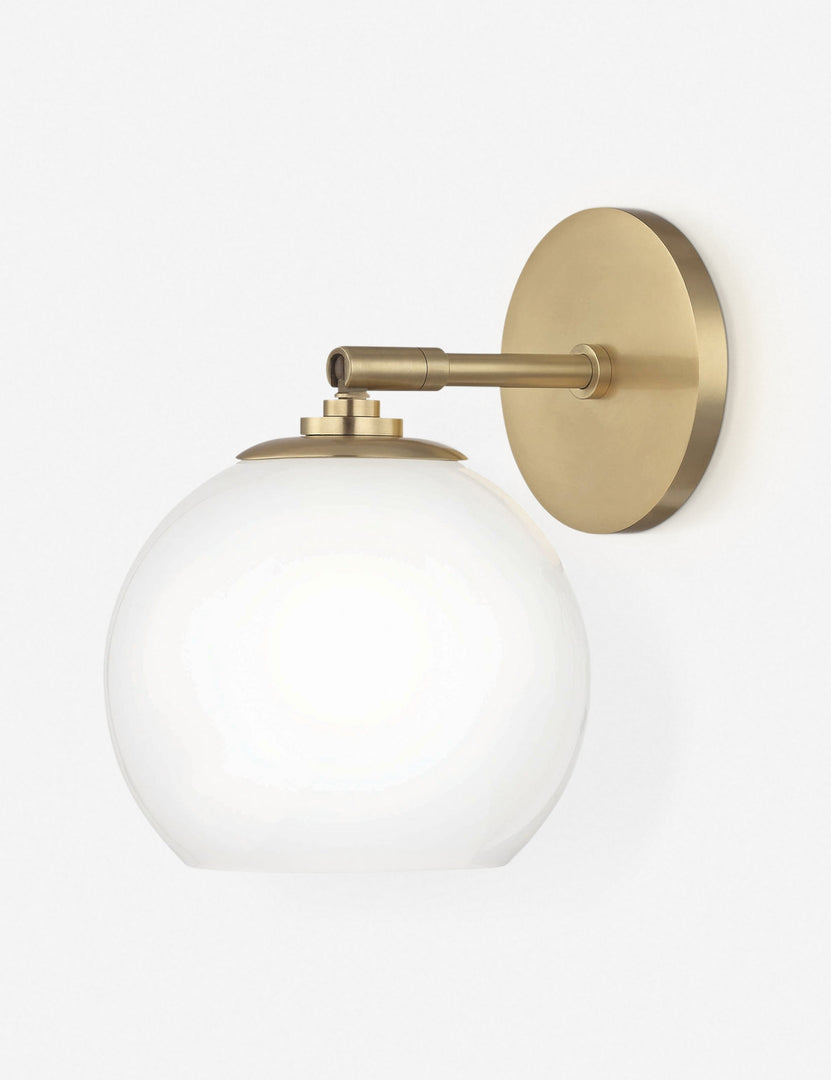 | Angled view of the Kai bistro-style sconce with brass hardware