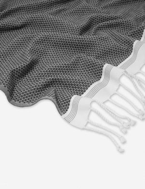 Close up of the Mediterranean Turkish Cotton gray Guest Towel by Coyuchi with tasseled ends