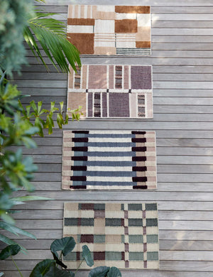 The Marli Rug in its two by three inch size lays on a hardwood floor outside with three other Nina Freudenberger rugs