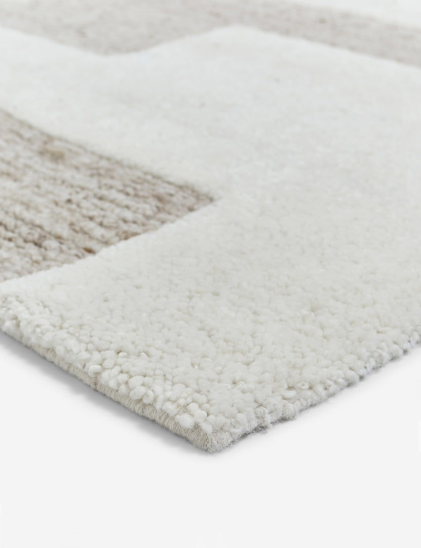 #size::6--x-9- #size::8--x-10- #size::9--x-12- #size::10--x-14- #size::12--x-15- | Close-up of the corner of the Oasis plush geometric neutral-toned rug by Élan Byrd