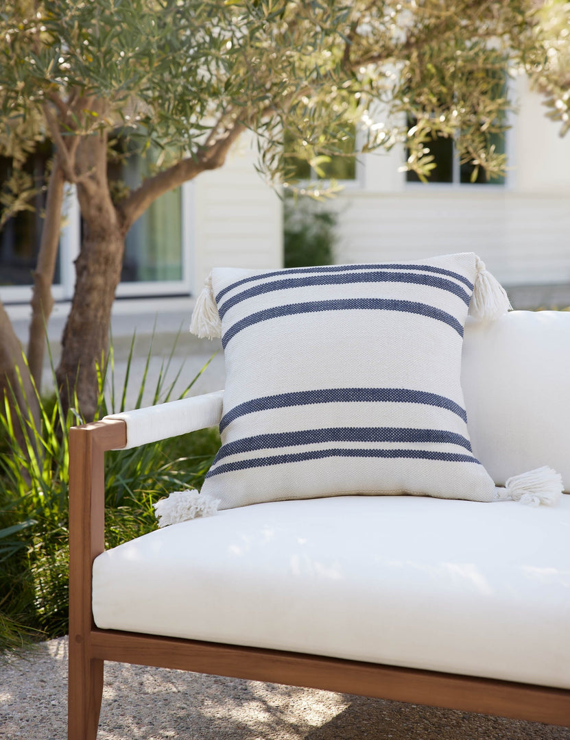 #color::slate | The Fez slate and white indoor and outdoor throw pillow sits on a white sofa in an outdoor space