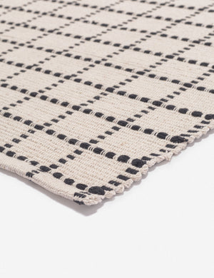 Corner-shot of the Sebou natural and black dotted machine washable mat