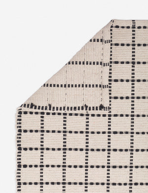 Corner-shot of the Sebou natural and black dotted machine washable mat