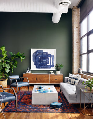 The cordelle media console sits in a saturated living room with a gray sofa and two leather accent chairs