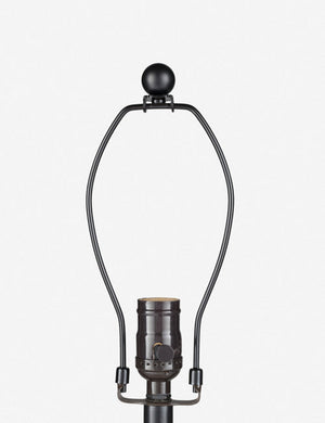 Close-up of the bronze light fixture on the Vivienne tan ceramic table lamp with spherical base